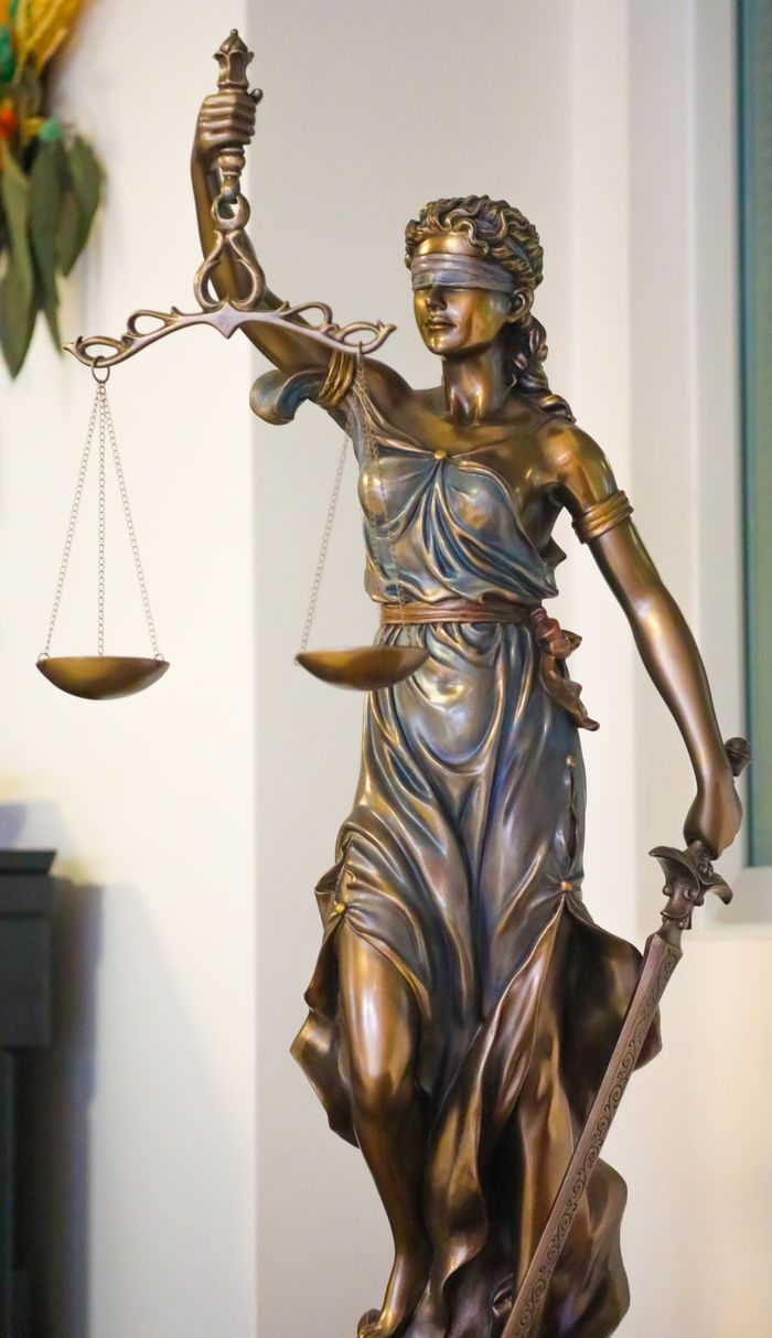Mastering the First Impression: Your intriguing post title goes here Bronze Lady Justice statue with scales and sword, symbolizing law and fairness, displayed indoors in İstanbul.