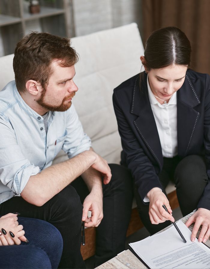 Services Business professionals in a meeting reviewing significant documents in an office setting.